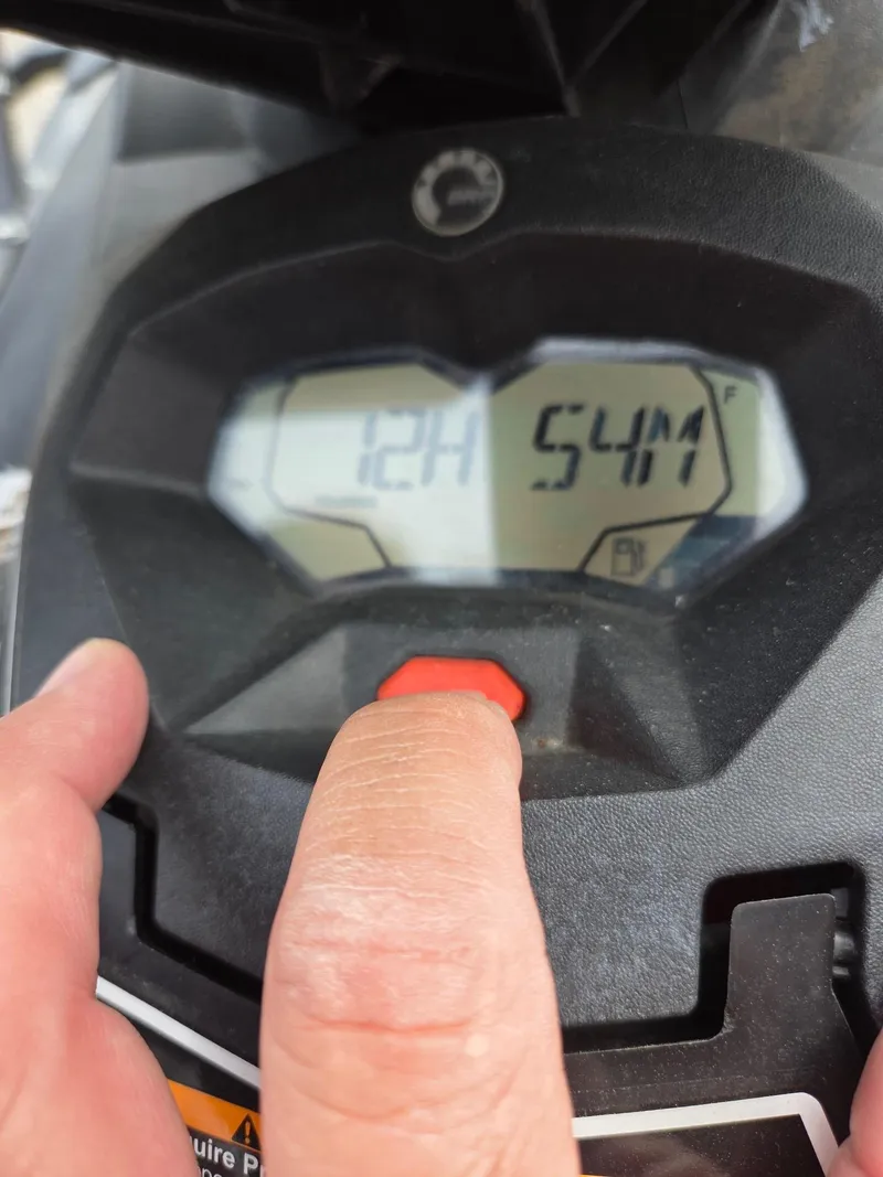 Slide: The Image of Close-up of 2021 Sea-Doo Spark 2up dashboard with digital display and finger pressing button. - 6