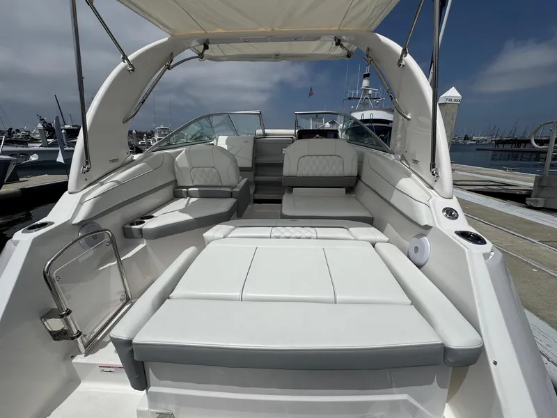 Slide: The Image of 2025 Regal 26 XO boat interior with white seating, docked at marina. - 11