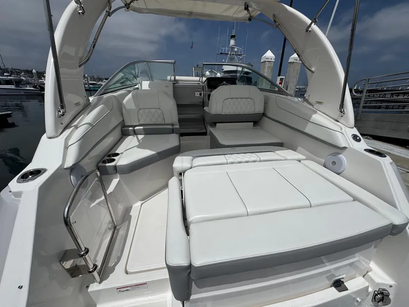 Slide: The Image of 2025 Regal 26 XO boat interior with white seating, docked at marina. - 12