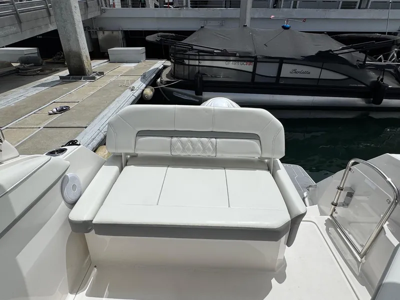 Slide: The Image of 2025 Regal 26 XO boat with white seating at a marina dock. - 15