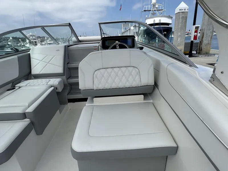 Slide: The Image of 2025 Regal 26 XO boat interior with luxurious seating and modern design at a marina. - 21