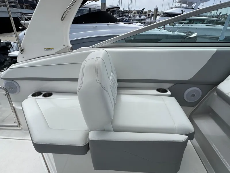 Slide: The Image of 2025 Regal 26 XO boat interior with white seating and cup holders. - 23