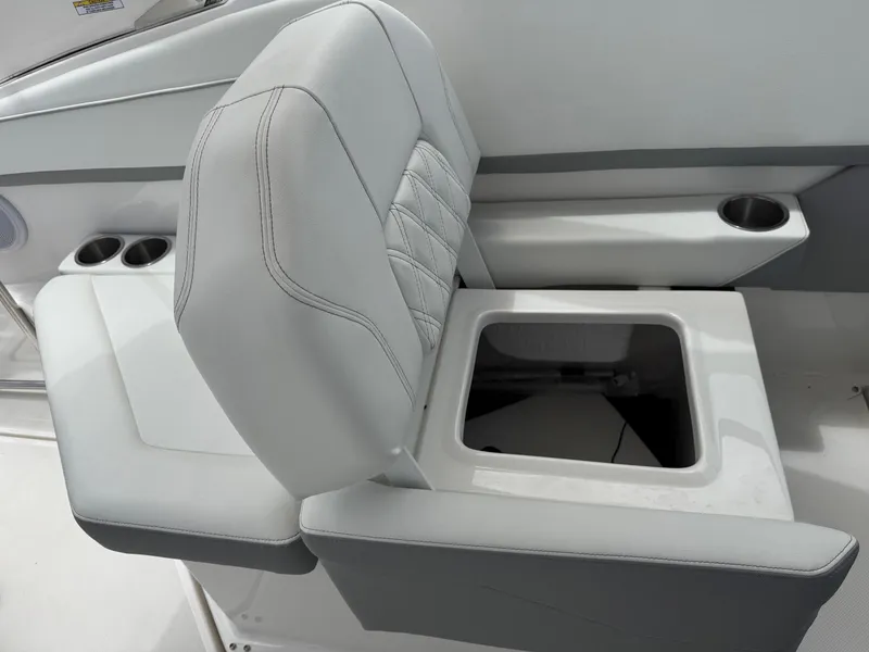 Slide: The Image of 2025 Regal 26 XO boat seat with integrated storage and cup holders. - 24