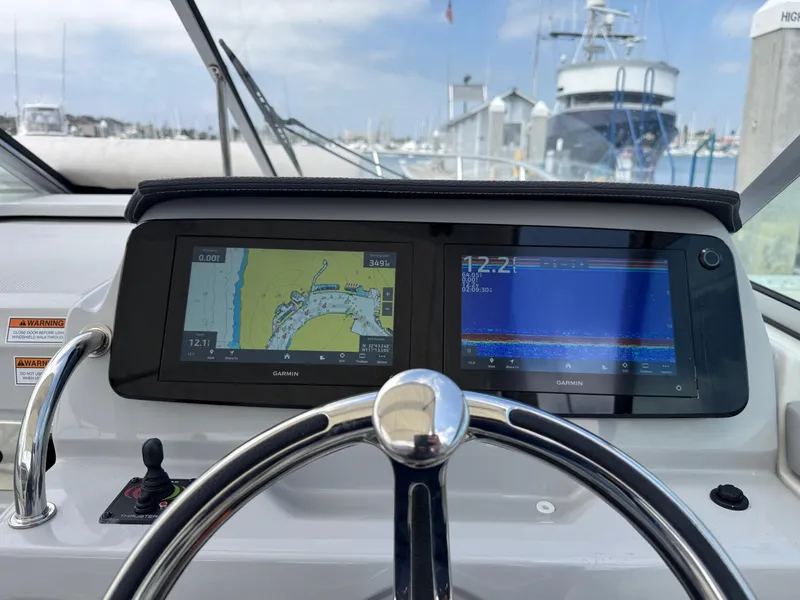 Slide: The Image of Helm of 2025 Regal 26 XO boat with navigation screens and steering wheel. - 28