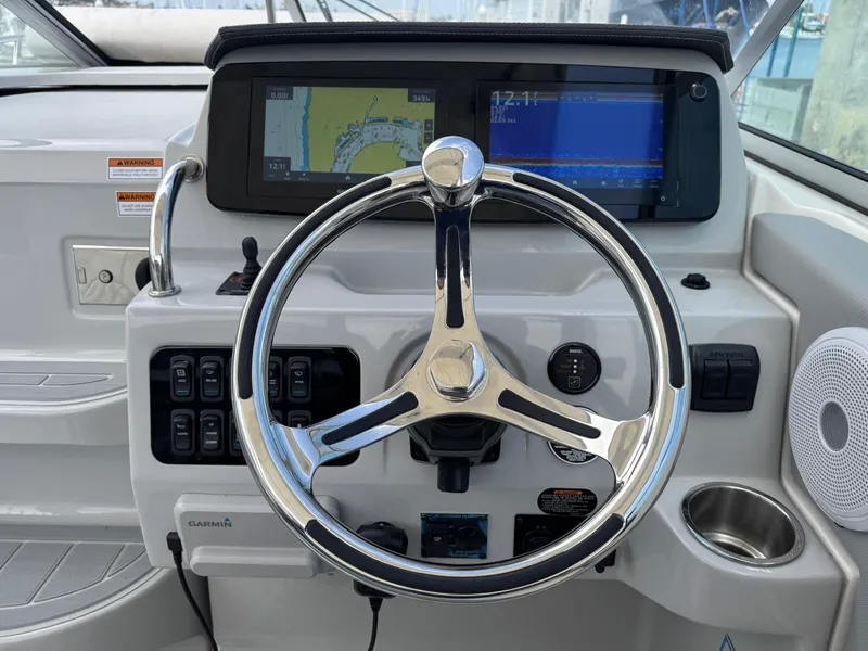 Slide: The Image of Helm of 2025 Regal 26 XO boat with steering wheel and navigation display. - 29