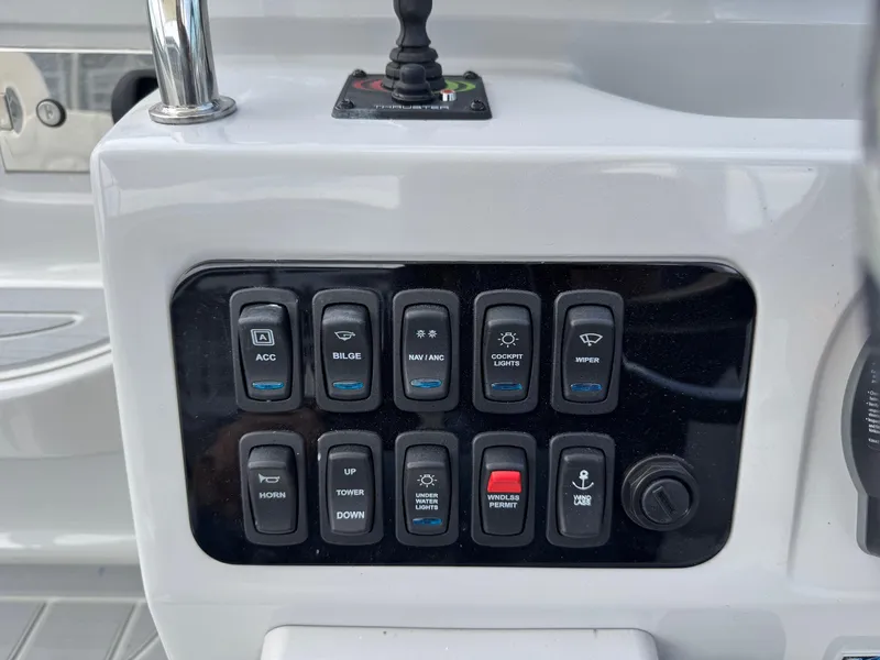 Slide: The Image of Control panel of 2025 Regal 26 XO boat with various switches and buttons. - 30