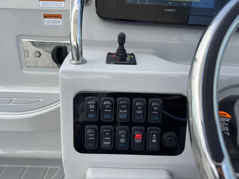 Slide: The Image of Control panel of 2025 Regal 26 XO boat with switches and joystick. - 31