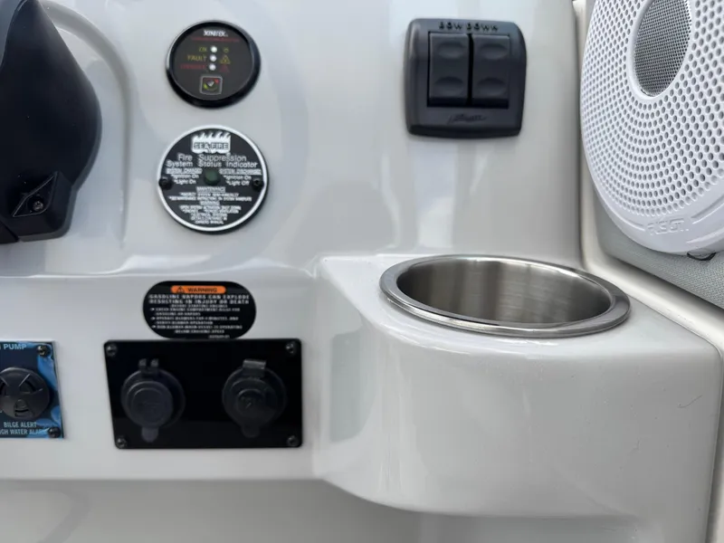 Slide: The Image of Control panel of 2025 Regal 26 XO boat with cup holder and speaker. - 33