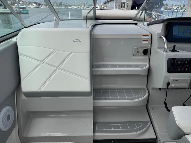 Slide: The Image of 2025 Regal 26 XO boat interior with sleek seating and modern control panel. - 34