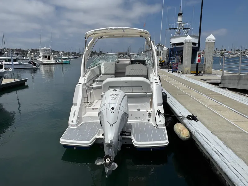 Slide: The Image of 2025 Regal 26 XO boat docked at marina, rear view with outboard motor. - 4