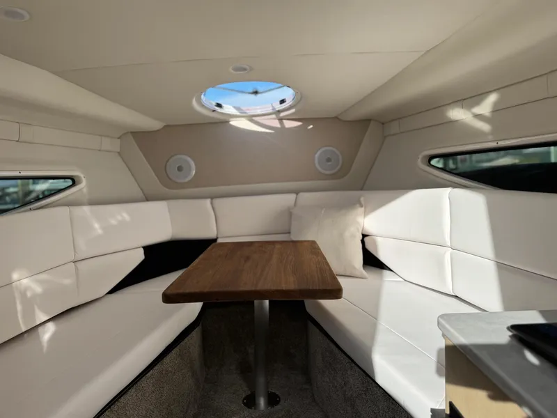 Slide: The Image of Interior of 2025 Regal 26 XO boat with white seating and wooden table. - 41