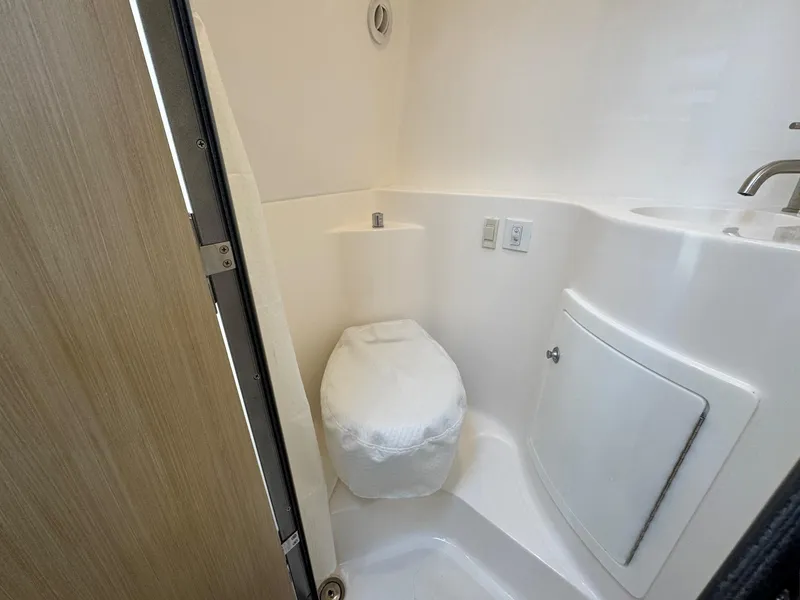 Slide: The Image of 2025 Regal 26 XO boat bathroom with compact toilet and sink. - 46