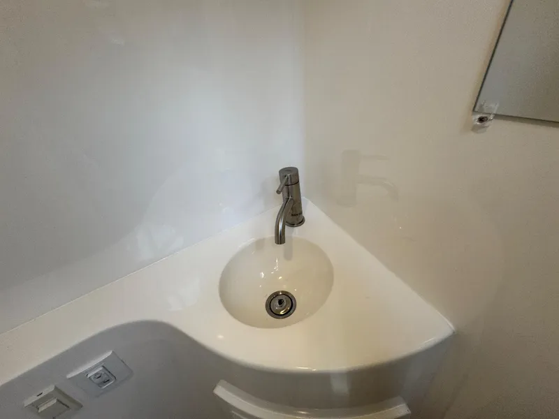 Slide: The Image of Compact sink in 2025 Regal 26 XO boat bathroom. - 48