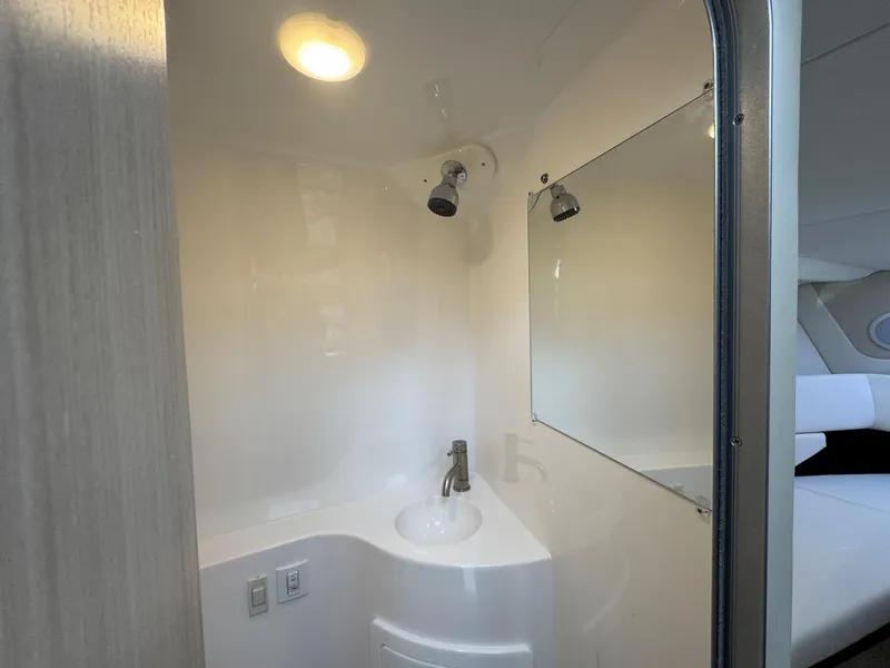 Slide: The Image of 2025 Regal 26 XO boat bathroom with modern fixtures and lighting. - 49