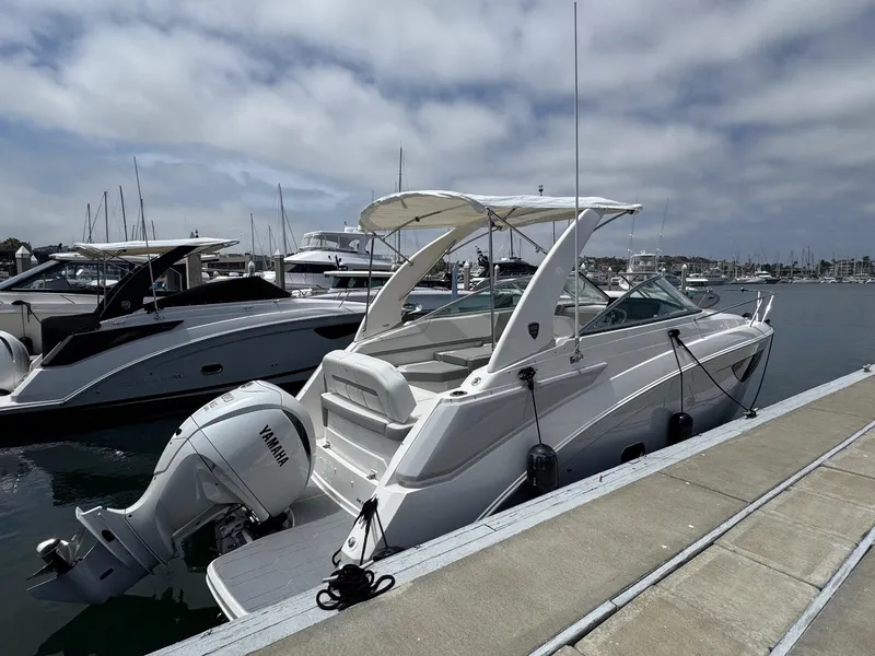 Slide: The Image of 2025 Regal 26 XO boat docked, featuring a Yamaha outboard motor, under a cloudy sky. - 5