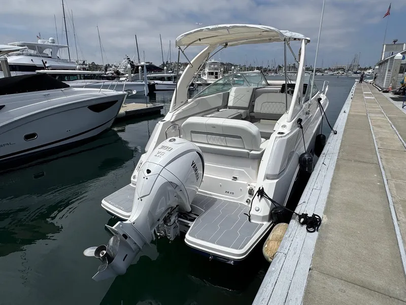 Slide: The Image of 2025 Regal 26 XO boat docked at marina, featuring sleek design and powerful outboard motor. - 6