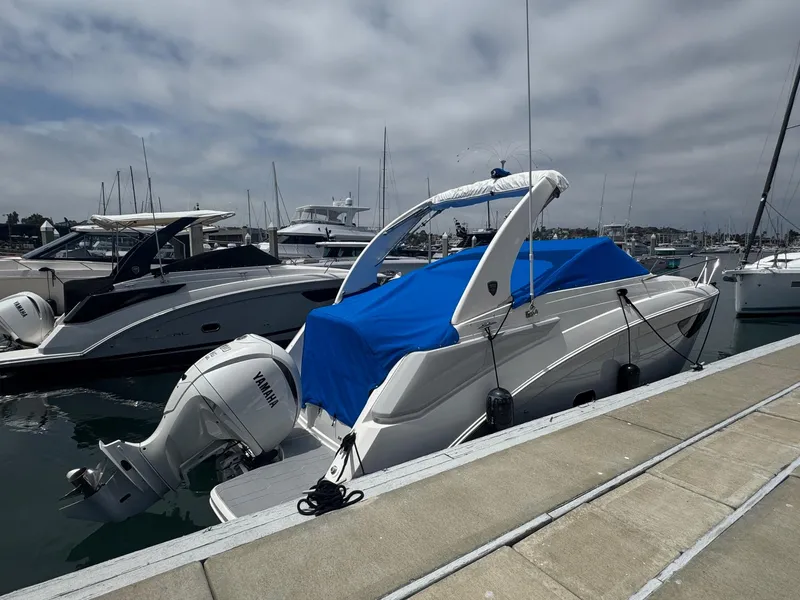 Slide: The Image of 2025 Regal 26 XO boat docked with blue cover and Yamaha outboard motor. - 67
