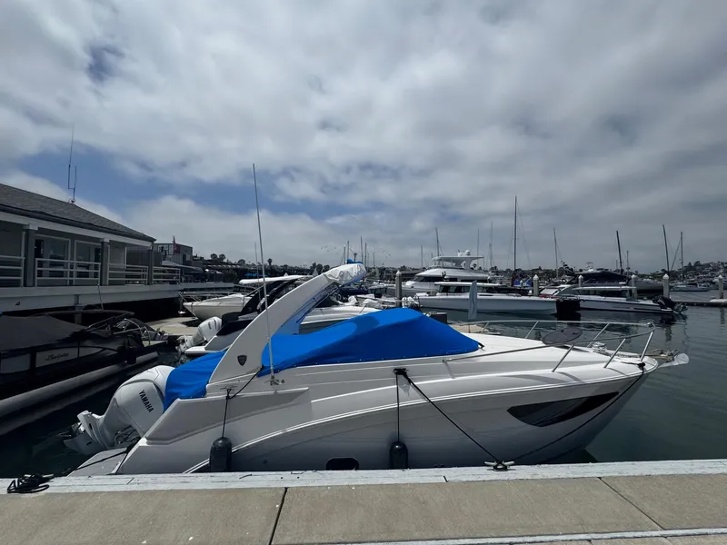 Slide: The Image of 2025 Regal 26 XO boat docked at marina under cloudy sky. - 68