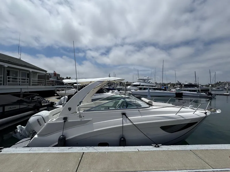 Slide: The Image of 2025 Regal 26 XO boat docked at a marina under a cloudy sky. - 7
