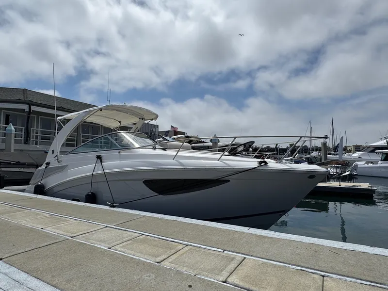 Slide: The Image of 2025 Regal 26 XO boat docked at marina under cloudy sky. - 8