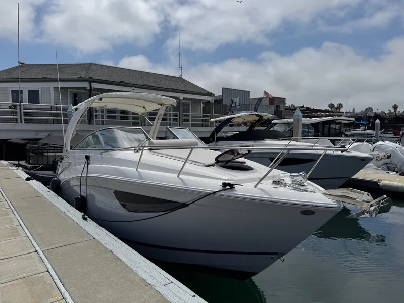 Slide: The Image of 2025 Regal 26 XO boat docked at marina under cloudy sky. - 9