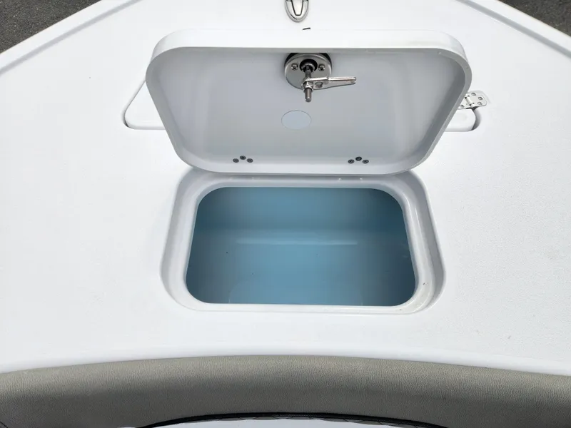 Slide: The Image of 2025 Sportsman Masters 247OE Bay Boat storage compartment with open lid, showcasing interior space. - 13
