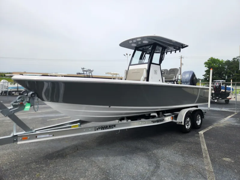 Slide: The Image of 2025 Sportsman Masters 247OE Bay Boat on trailer, gray hull, parked outdoors. - 7