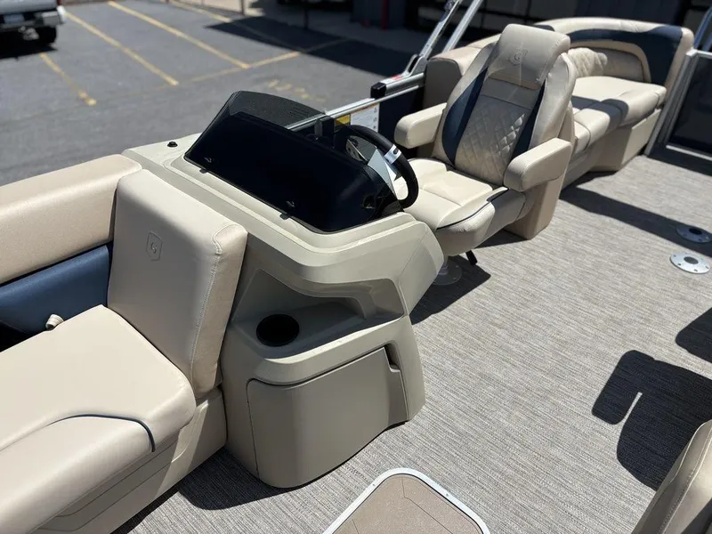 Slide: The Image of 2025 Godfrey SWEETWATER 2286 SB boat interior with beige seating and steering console. - 10