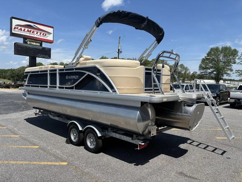Slide: The Image of 2025 Godfrey SWEETWATER 2286 SB pontoon boat on trailer in parking lot. - 17