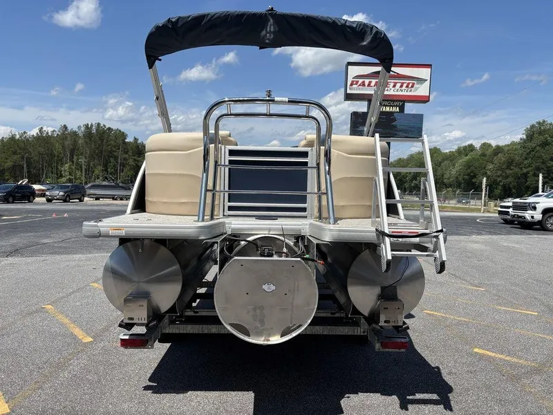 Slide: The Image of 2025 Godfrey SWEETWATER 2286 SB pontoon boat, rear view, parked outdoors. - 18