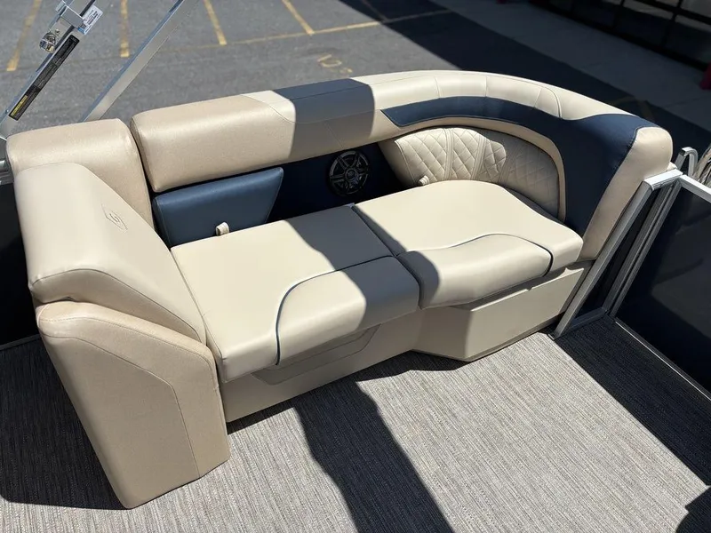 Slide: The Image of Luxurious seating on 2025 Godfrey SWEETWATER 2286 SB pontoon boat, featuring beige and navy upholstery. - 2