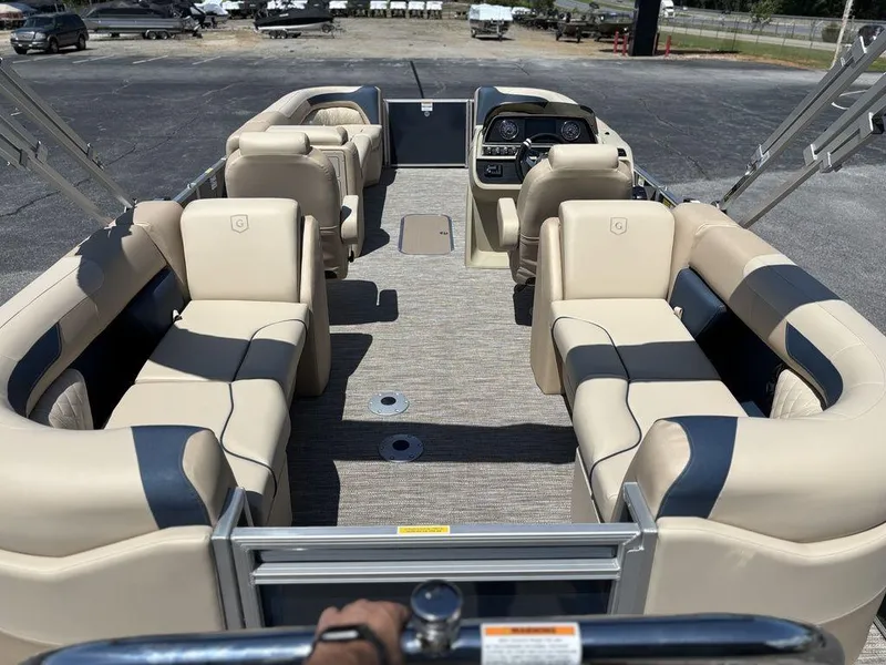 Slide: The Image of 2025 Godfrey SWEETWATER 2286 SB pontoon boat interior with beige seating and steering console. - 3