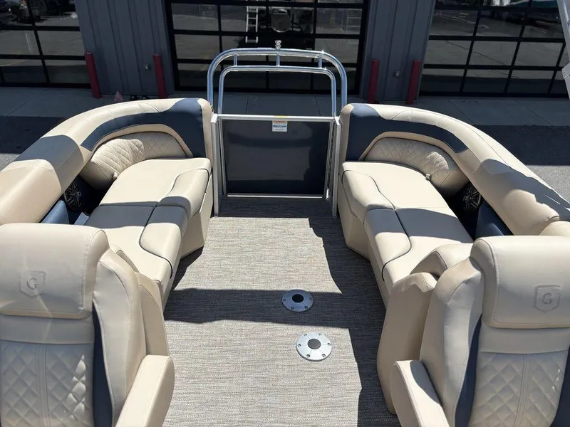 Slide: The Image of 2025 Godfrey SWEETWATER 2286 SB pontoon boat interior with beige seating and carpeted floor. - 5