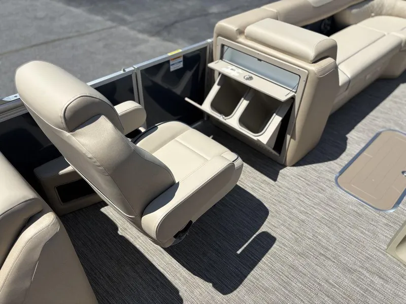 Slide: The Image of 2025 Godfrey SWEETWATER 2286 SB boat interior with beige seating and storage compartments. - 6