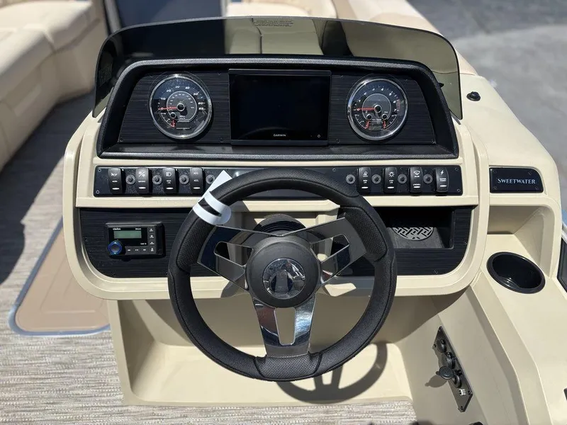 Slide: The Image of 2025 Godfrey SWEETWATER 2286 SB boat dashboard with steering wheel and control panel. - 7