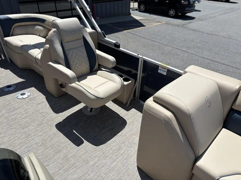 Slide: The Image of 2025 Godfrey SWEETWATER 2286 SB boat interior with beige seating and modern design. - 9