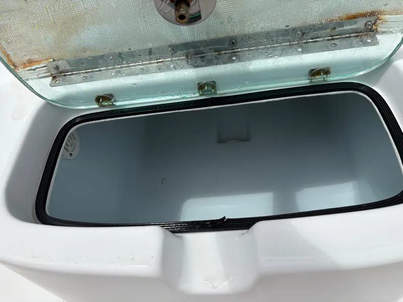 Slide: The Image of Open storage compartment on 2015 Cape Horn 27X3 boat, featuring a clean interior. - 10