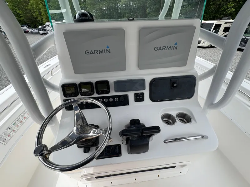 Slide: The Image of Control panel of 2015 Cape Horn 27X3 boat with Garmin displays and steering wheel. - 12