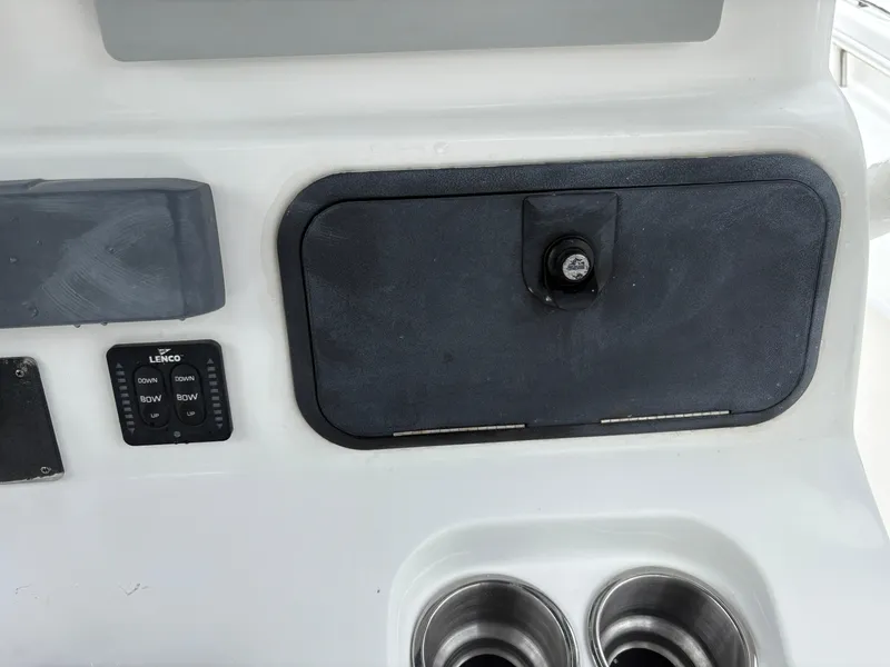 Slide: The Image of Control panel of a 2015 Cape Horn 27X3 boat with storage compartment and cup holders. - 14