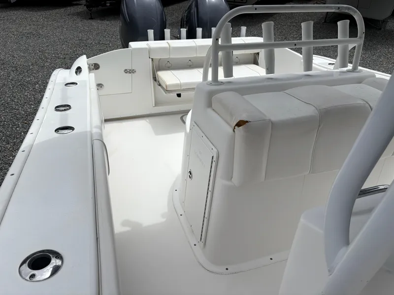 Slide: The Image of 2015 Cape Horn 27X3 boat interior with white seating and dual engines. - 16