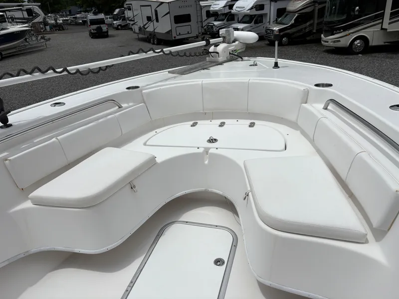 Slide: The Image of 2015 Cape Horn 27X3 boat interior with white cushioned seating in a marina. - 17