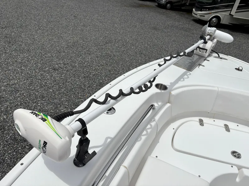 Slide: The Image of 2015 Cape Horn 27X3 boat with trolling motor on deck, parked on gravel. - 20