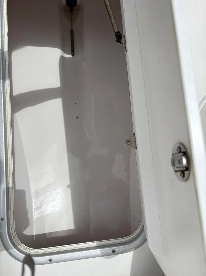 Slide: The Image of 2015 Cape Horn 27X3 storage compartment with open hatch and latch detail. - 22