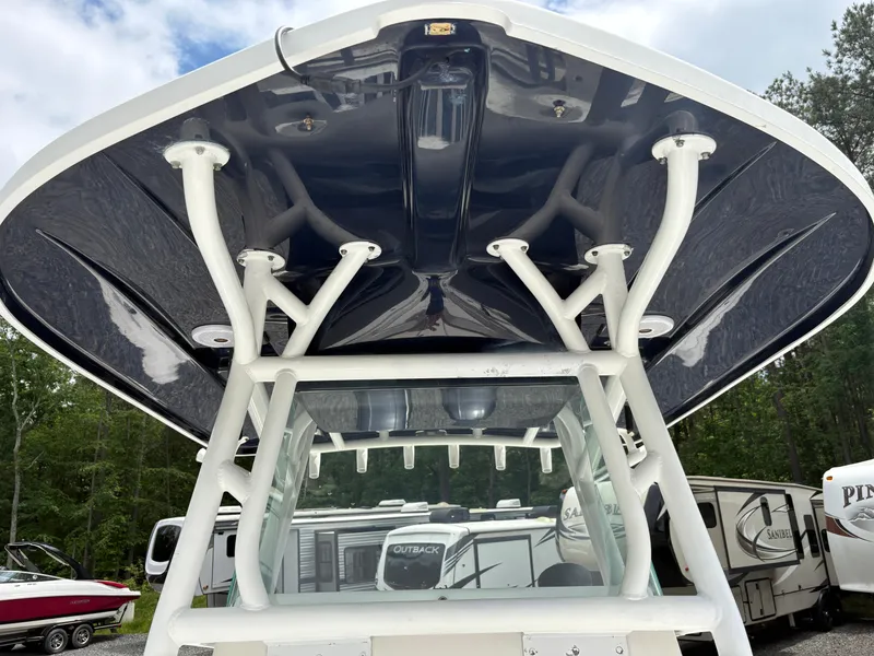 Slide: The Image of 2015 Cape Horn 27X3 boat with T-top, parked near RVs and trees. - 23