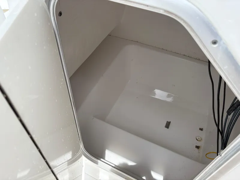 Slide: The Image of Storage compartment of a 2015 Cape Horn 27X3 boat, showing interior space and wiring. - 25