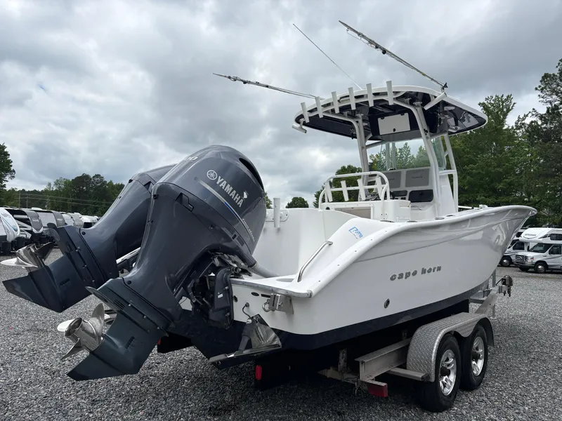 Slide: The Image of 2015 Cape Horn 27X3 boat with dual Yamaha engines on a trailer, parked outdoors. - 5