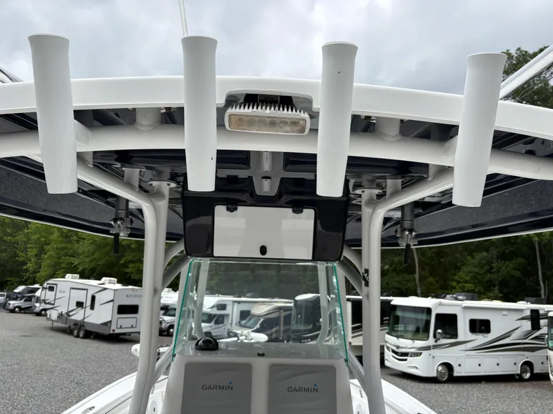 Slide: The Image of 2015 Cape Horn 27X3 boat with rod holders and Garmin equipment, parked near RVs. - 8