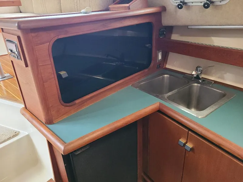 Slide: The Image of 1989 Bayliner 3255 Avanti kitchen area with sink, countertop, and storage. - 18