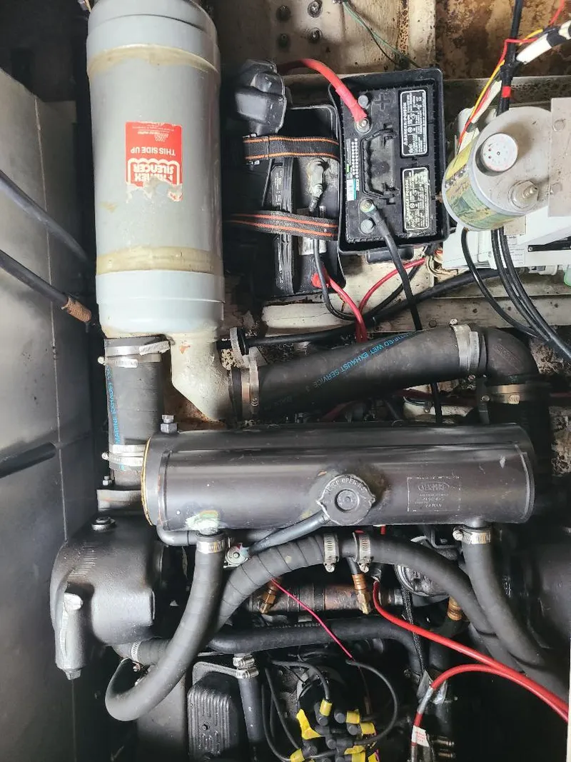 Slide: The Image of Engine compartment of a 1989 Bayliner 3255 Avanti boat, showing mechanical components and wiring. - 22