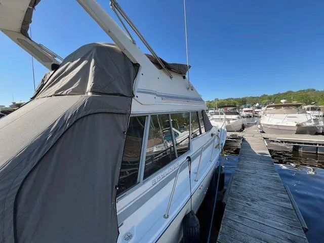 Slide: The Image of 1989 Bayliner 3255 Avanti docked at marina under clear blue sky. - 6